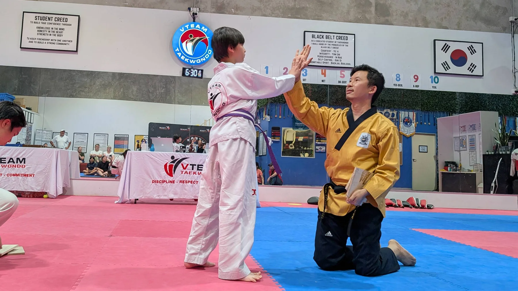 Master Eric high-fives a young student at VTEAM